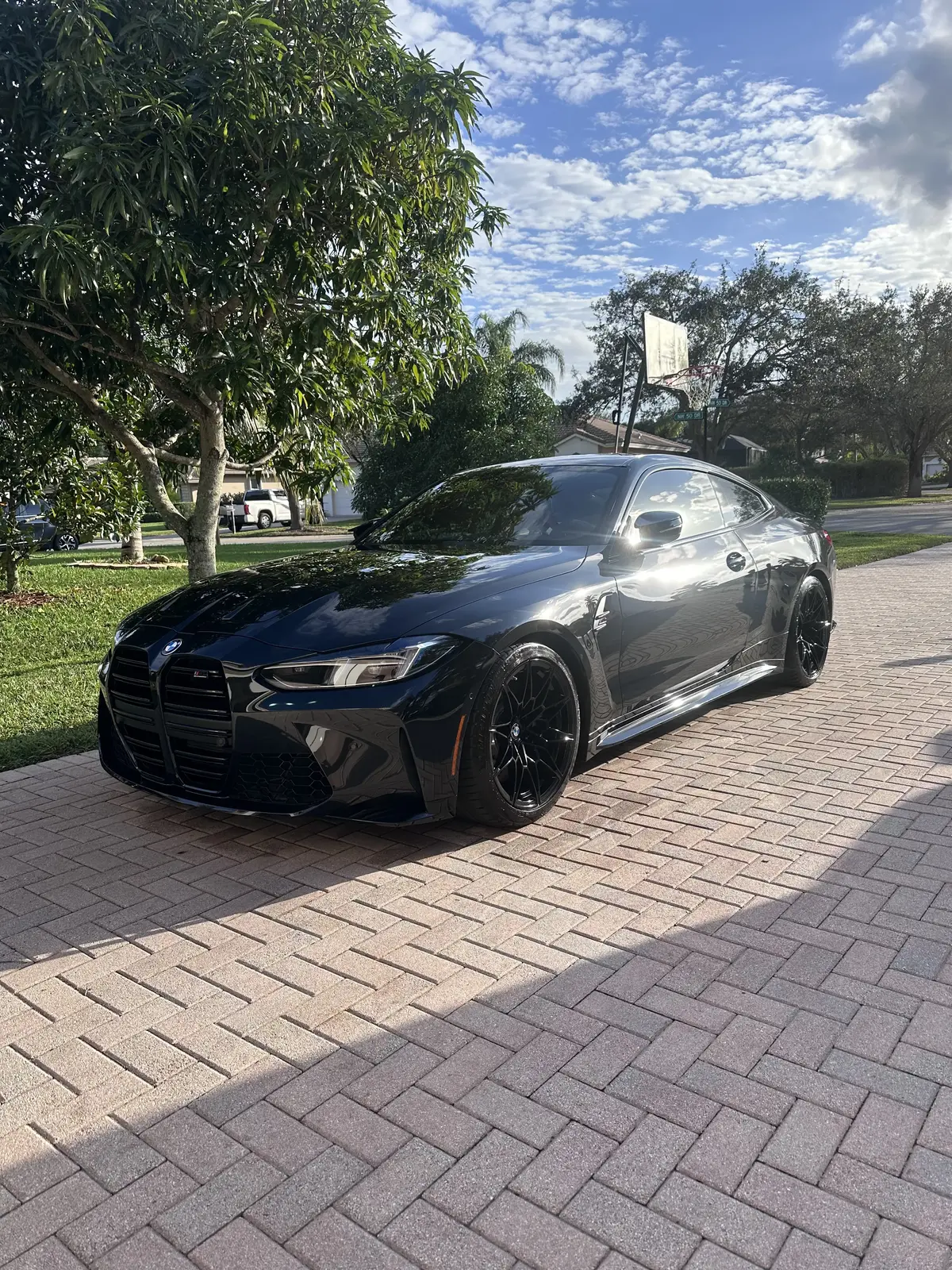 Professional mobile car detailing on a black BMW M4 in South Florida