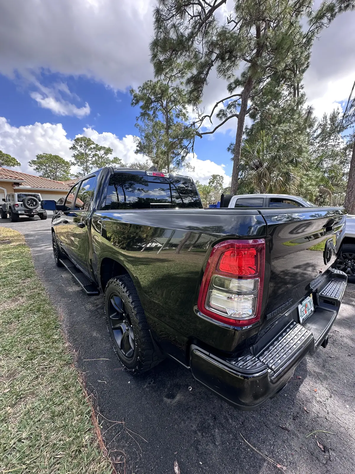 Black RAM 1500 truck rear view showing mirror-like paint finish after detailing